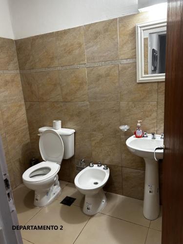 a bathroom with a toilet and a sink at Sabattini Apart in Villa María