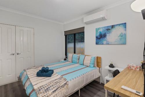 a bedroom with a bed with a blue towel on it at 13 Family Home In Morley Sleeps 6 Comfortably in Perth