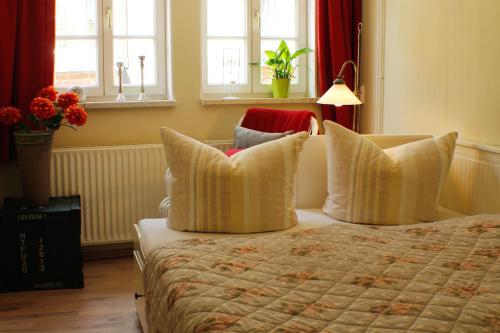 クヴェードリンブルクにあるFerienhaus Stobenstrasseのベッドルーム(枕、ランプ付)