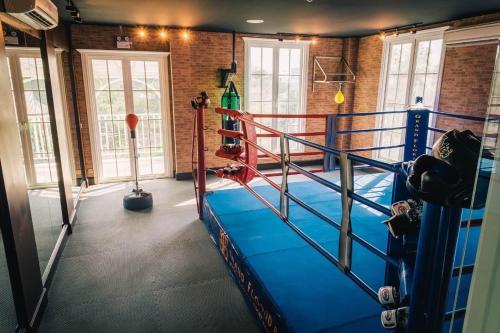 a gym with a boxing ring in a room at Grand Florida Beach condo in Na Jomtien