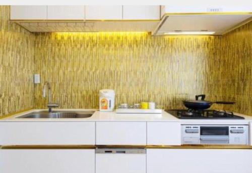 a kitchen with a sink and a stove in it at Reimi Mondo401-8720 in Tokyo