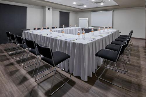 a long table in a room with chairs and a screen at City Express by Marriott La Raza in Mexico City