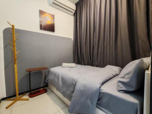 a small room with a bed and a window at Modern Elegance Suite, 5 to 6 pax at Urban Suites Georgetown by SuperStay in Jelutong