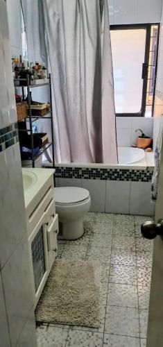 a bathroom with a toilet and a sink and a tub at Qosqo Plaza Retreat Lucrepata 2 in Cusco