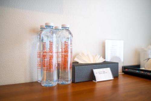 two glass bottles sitting on a table next to a box at Janpa Resort in Don Sak