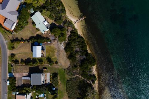 an aerial view of a beach and the ocean at The Blue House in Coles Bay