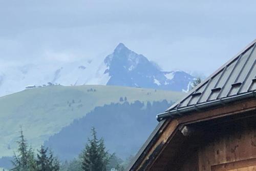 a view of a mountain from a roof of a house at Apartment with balcony and panoramic view between sky and mountains in Megève