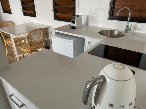 a kitchen with a white appliance on a counter at Fabulous 2 bedroom with private pool in Airlie Beach