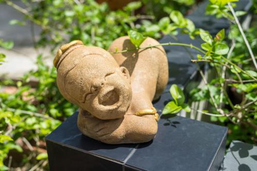 a statue of a teddy bear sitting on a table at Lanta Thip House by Swiss-Belhotel - SHA Plus in Ko Lanta