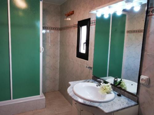 a bathroom with a sink and a shower and a mirror at VILLAS COSETTE / ¡Descubre Villa Martina, tu oasis perfecto en la Costa Brava! Fabulosa piscina y zona de Barbacoa! - ES-209-4 in Caldes de Malavella