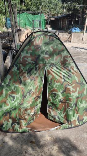 a camo tent sitting on the ground at Temple Ruins - Ke-In-Gir Ashram in Mae Sot