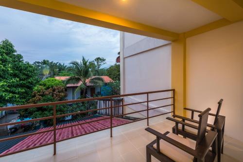 a balcony with a bench and a view at Lanta Thip House by Swiss-Belhotel - SHA Plus in Ko Lanta