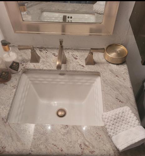 a white sink in a bathroom with a mirror at Perfect Inside Downtown Aspen Location! Romantic 1300 ft, 4 Blocks or 396 m, to AJAX or Aspen Mountain in Aspen