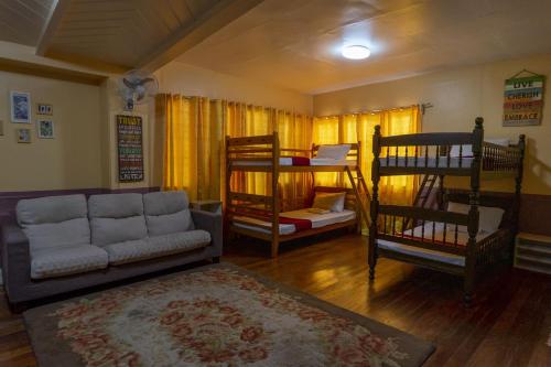 a living room with a couch and bunk beds at Old Orangewood Bed & Breakfast in Baguio