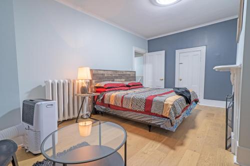 a bedroom with a bed and a glass table at Stylish Downtown Apartment in Halifax