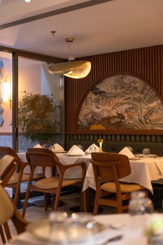 a dining room with tables and chairs and a mural at Kate Hotel Special Class & SPA in Istanbul
