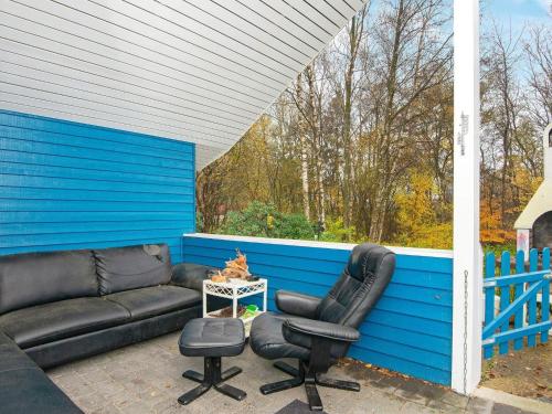 a couch and a chair on a patio at Lakefront Gem in Skarrild - By Traum Ferienwohnungen in Kibæk
