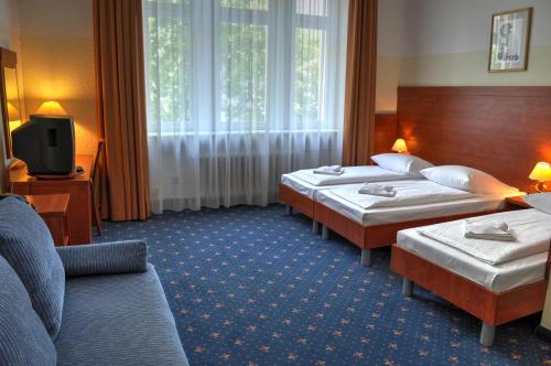 מיטה או מיטות בחדר ב-Hotel Europa City