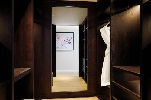 a dressing room with a mirror and a closet at The Westin London City in London