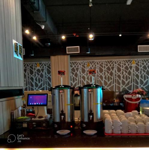 a kitchen with two fermenters and a counter with a computer at Hotel Langkasuka Langkawi in Kuah