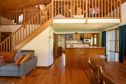 a living room with a couch and a table at Ethel - Drummond Park Cottages in Drummond