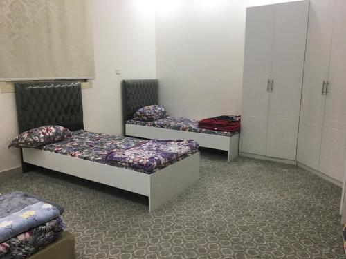 a room with two beds and cabinets in it at Traveler Rooms 2 in Medina