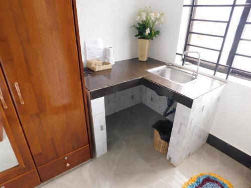 a kitchen with a sink and a counter at Tom's Place in Siem Reap