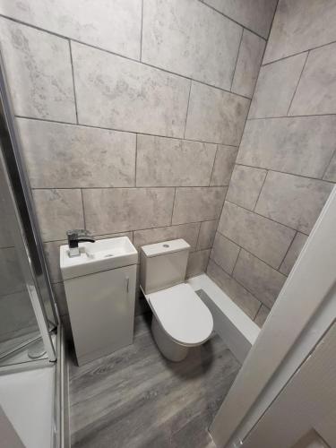 a small bathroom with a toilet and a sink at Hutton Lodge in Middlesbrough