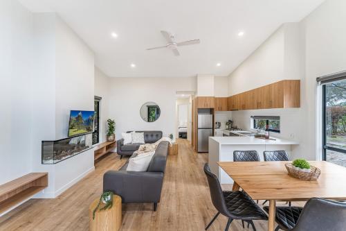 a living room with a couch and a table at Tasman Holiday Parks - South Bright in Bright