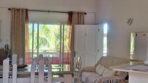 a living room with a table and a dining room at Grenadier A in Flic-en-Flac