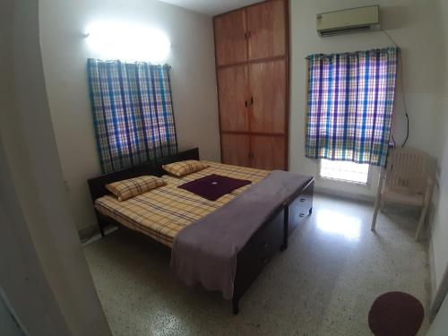 a bedroom with a large bed in a room at GG Homes - Apollo/Shankara Hospital in Chennai