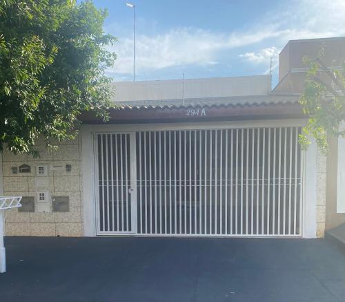 a garage with a large white garage door at Casa de Temporada Ferreira in Olímpia