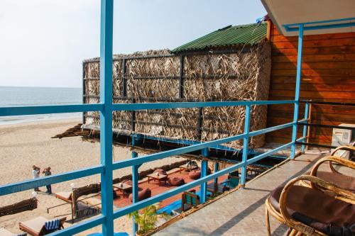 a view of the beach from the balcony of a beach house at New Common Home in Agonda
