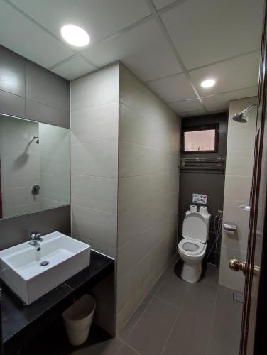a bathroom with a sink and a toilet at Sunrise View One Bedroom Apartment at Equatorial Hill Resort in Brinchang