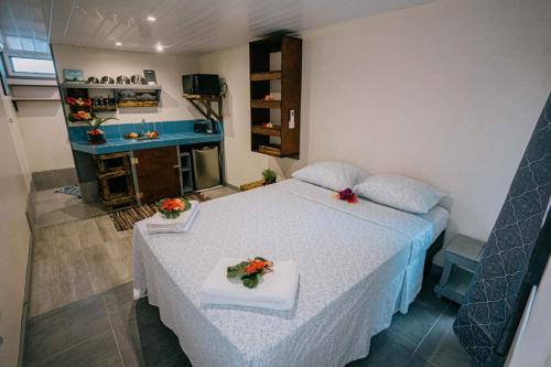 a bedroom with a bed with flowers on it at Mianahere Studio Bora Bora in Bora Bora
