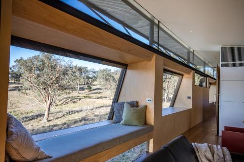 a room with a large window in a house at Strikes 3 in Eurunderee