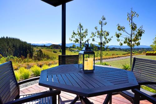 a blue table with a lantern sitting on a patio at Harakeke Boutique Accommodation in Mahana