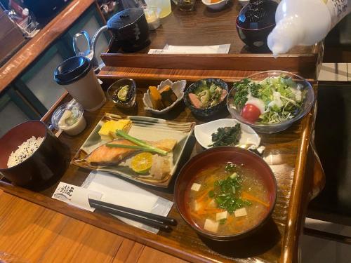 a tray with bowls of food on a table at Arimabaru Beach Resort in Motobu