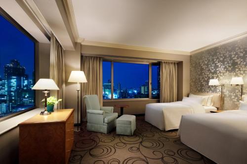 a hotel room with two beds and a window at The Westin Osaka in Osaka