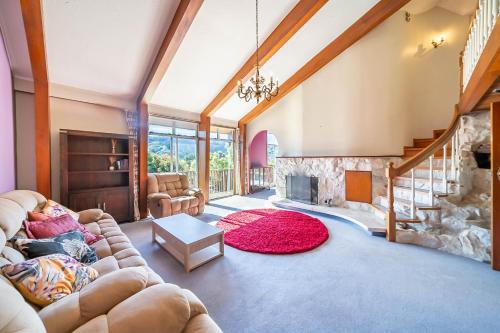 een woonkamer met een bank en een open haard bij Eclectic Luxurious 70s Mansion in Wellington