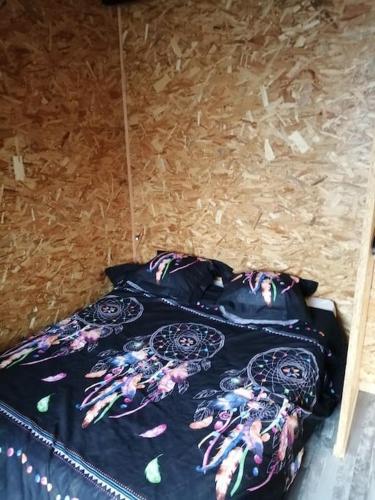 a bed sitting on top of a wooden floor at Cabane perchée in Saint-Brieuc