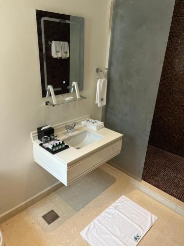 a bathroom with a sink and a mirror at Dibba Mountain Park Resort in Fujairah