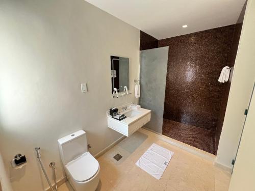 a bathroom with a toilet and a sink and a shower at Dibba Mountain Park Resort in Fujairah