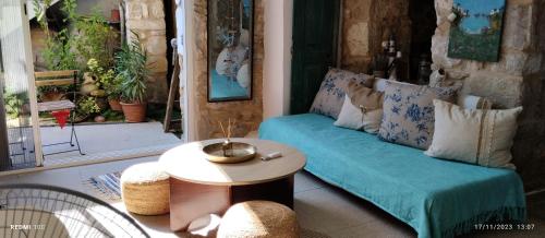 a living room with a couch and a table at Gallery House Plouti in Ploutí