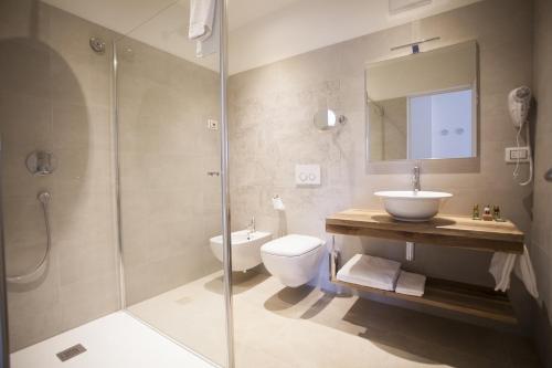 a bathroom with a toilet and a sink and a shower at Villa Italia Luxury Suites and Apartments in Arco