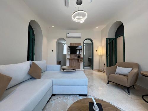 a living room with a white couch and a chair at Dibba Mountain Park Resort in Fujairah