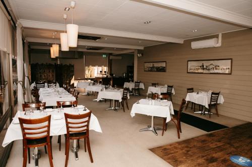 a dining room with white tables and chairs at Hospitality Kalgoorlie, SureStay Collection by Best Western in Kalgoorlie