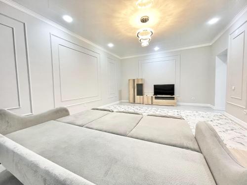 a large white room with a large bed at # 67 Привлекательная и просторная студия in Atyraū