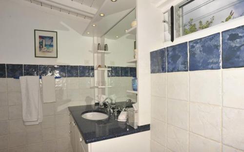 a bathroom with a sink and a mirror at Saint Barth Villa 7 in Pointe Milou