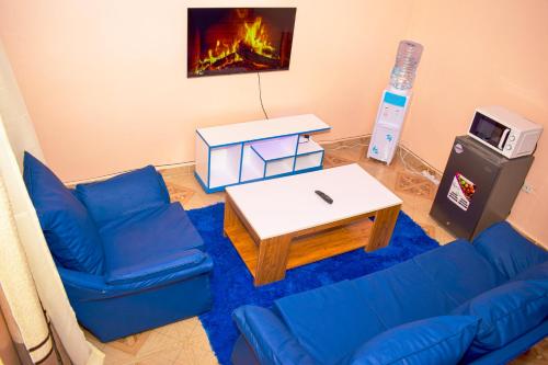 a living room with a couch and a coffee table at Furnished one bedroom bnb in thika town, jomoko in Thika